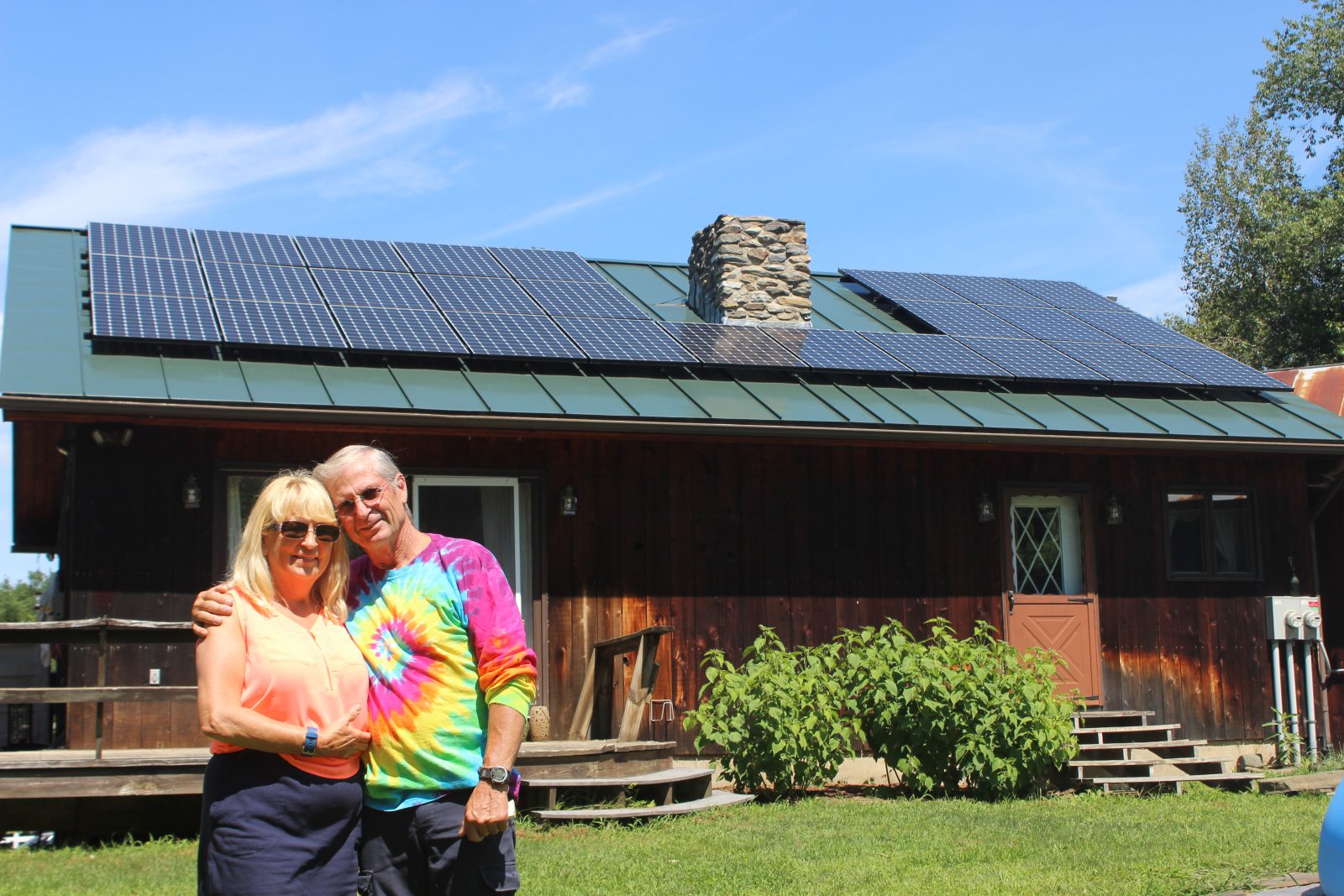 Happy home owners posing in front of their solar home in Windsor, Vermont 2