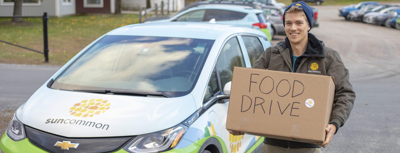 SunCommon Employee Carries Food Donation Box